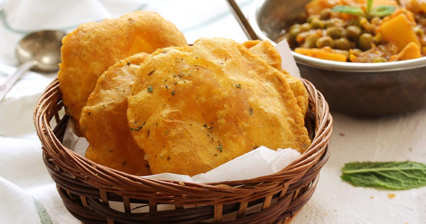 Enjoy a delicious culinary journey with the traditional Indian dish of aloo puri - an irresistible combination of potatoes, spices, and puffed deep-fried bread. Try it today! SEO keywords: aloo puri.