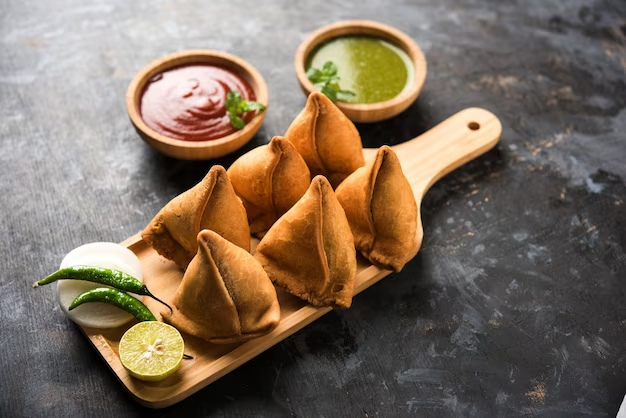 samosas, cultural icon, Indian cuisine, appetizer, snack, vegetarian, spice, flavor, history, cultural significance